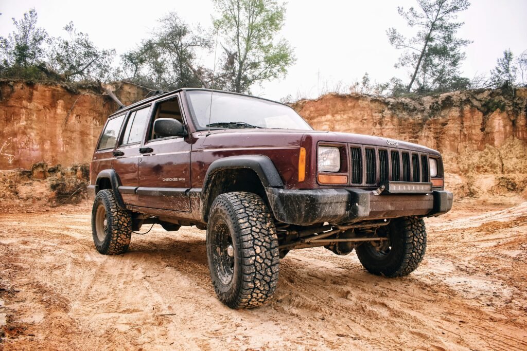 Truck with all terrain tires driving on dirt road in Temple TX
